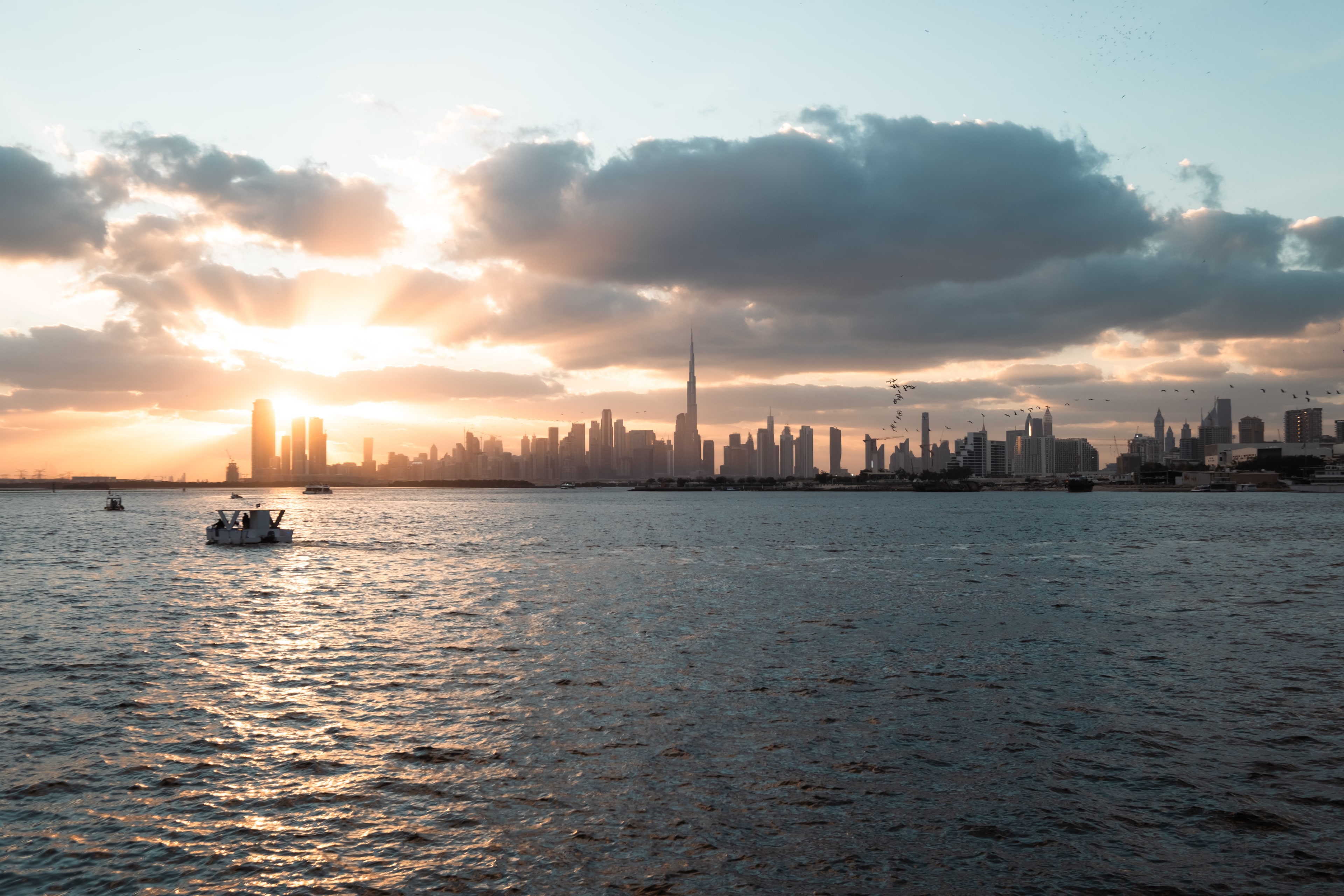 Real sunset photograph across Dubai Water Canal toward Downtown Dubai
